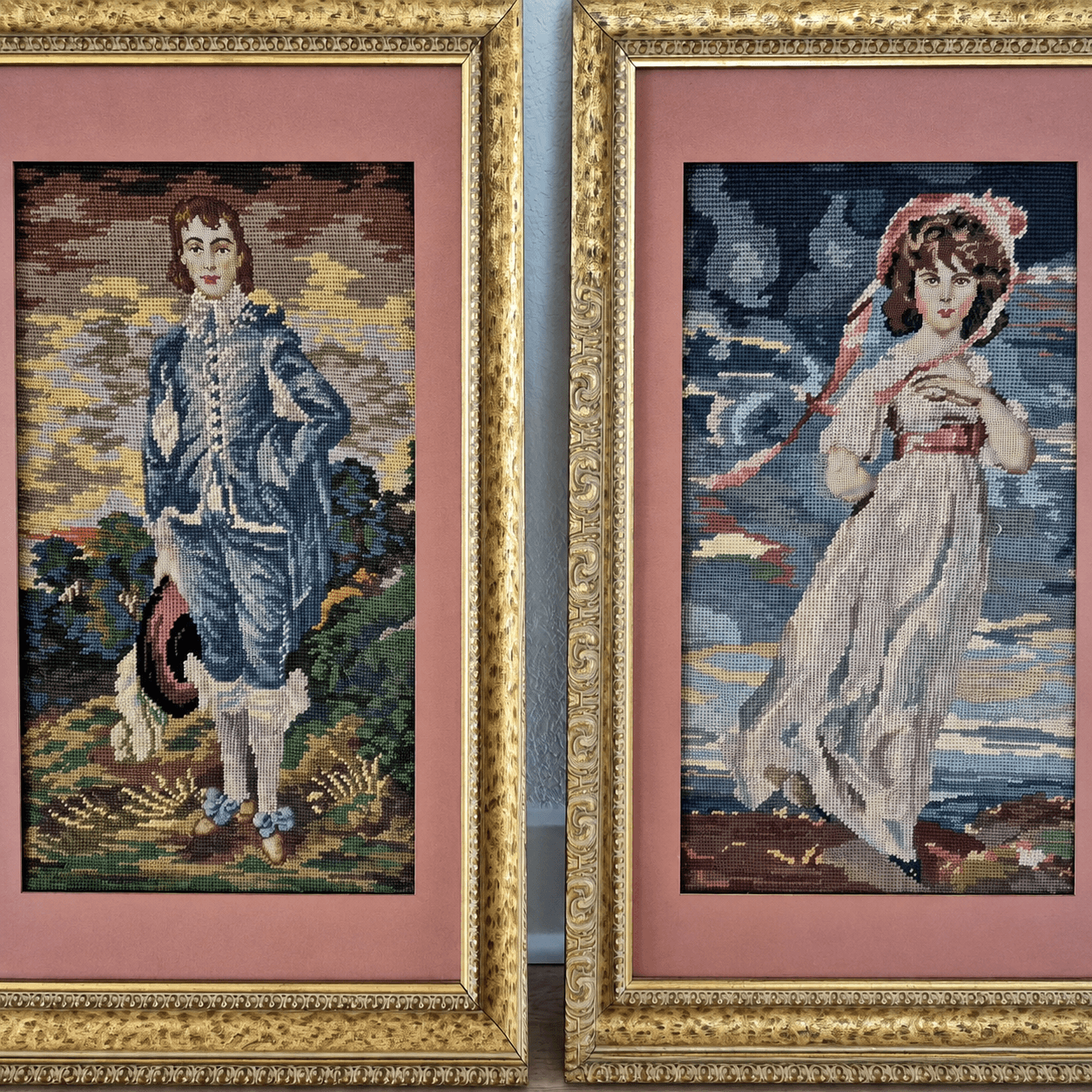 A pair of needlepoint portraits framed in gold and pink